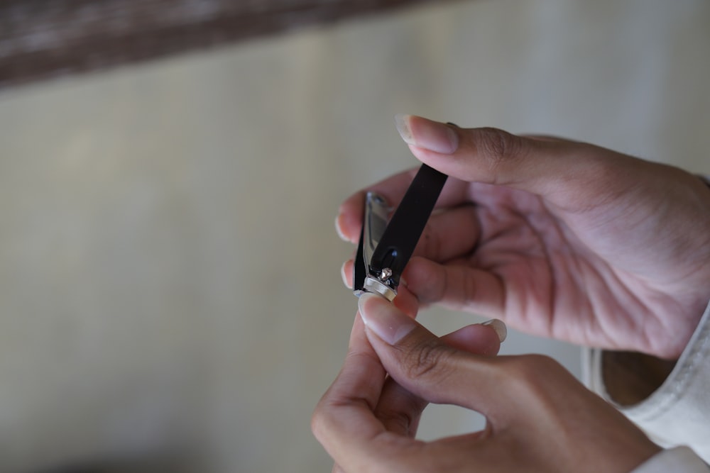 a person holding a cigarette in their hand