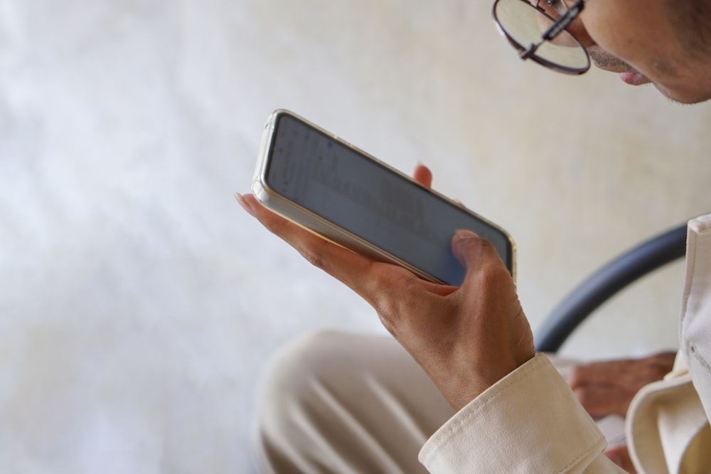 a close up of a person holding a cell phone