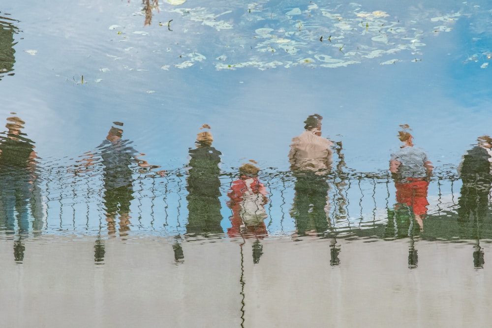 a group of people standing next to each other on a bridge