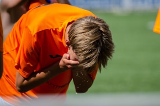 An athlete stepping out of an ice bath, sunlight highlighting determination on their face.
