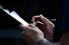 Close-up of a risk assessment checklist being filled out with a pen.