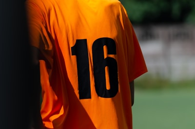 a close up of a soccer jersey with the number sixteen on it