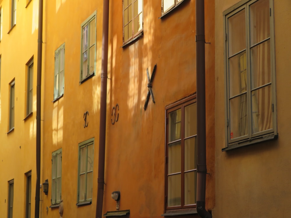 a row of buildings with windows and a clock on the side