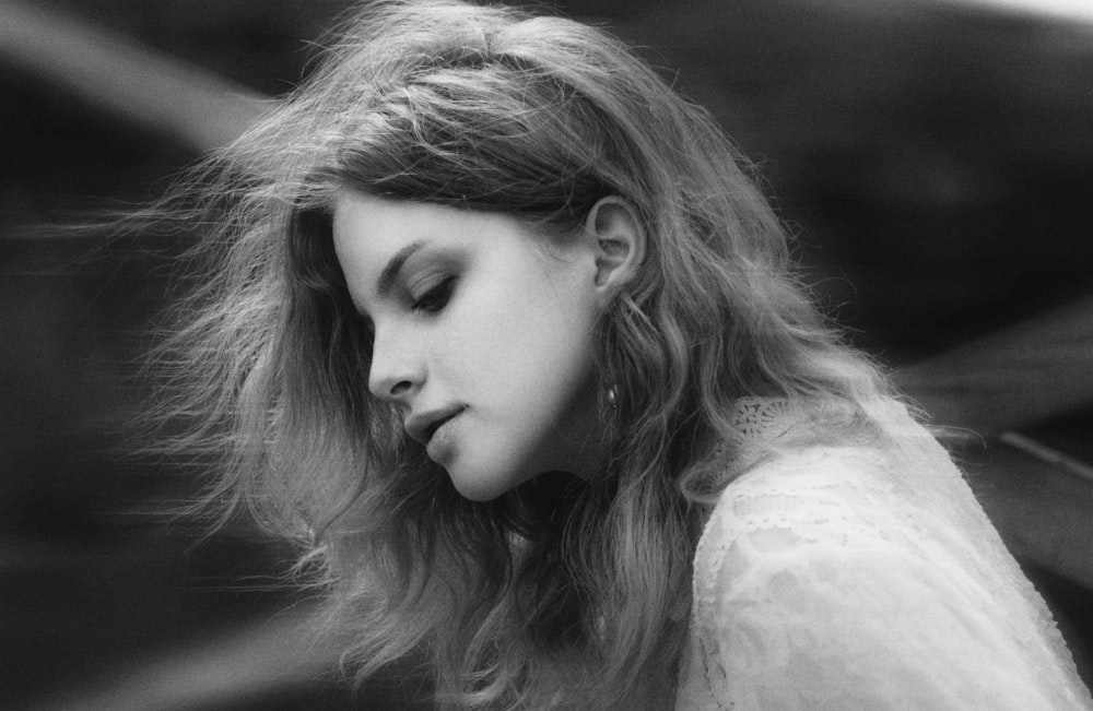 a black and white photo of a woman with her eyes closed