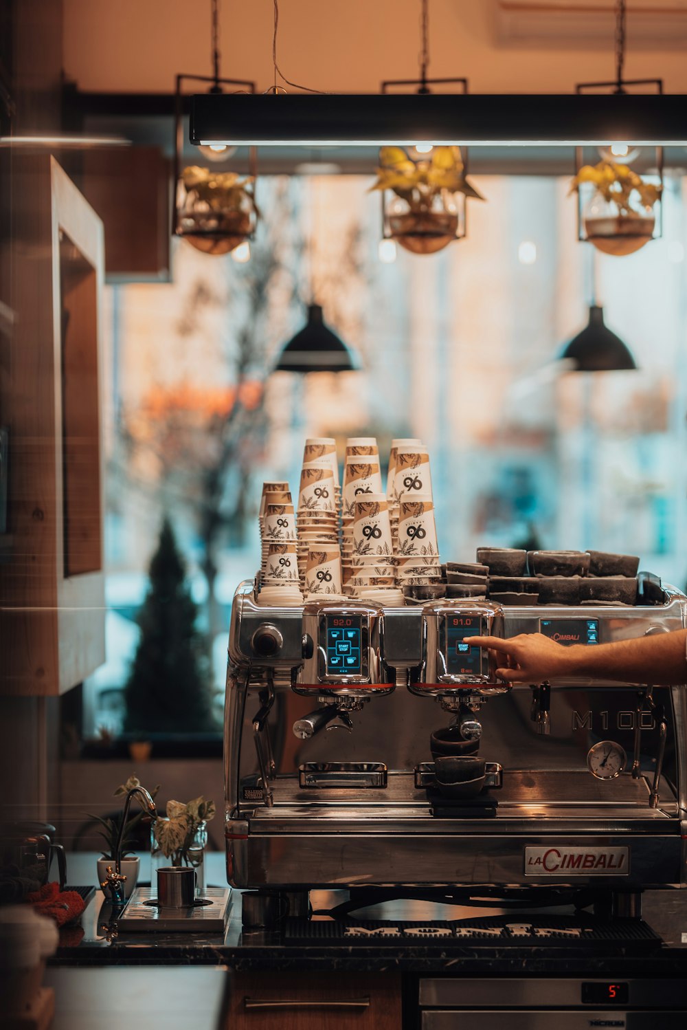 a coffee machine with coffee cups on top of it