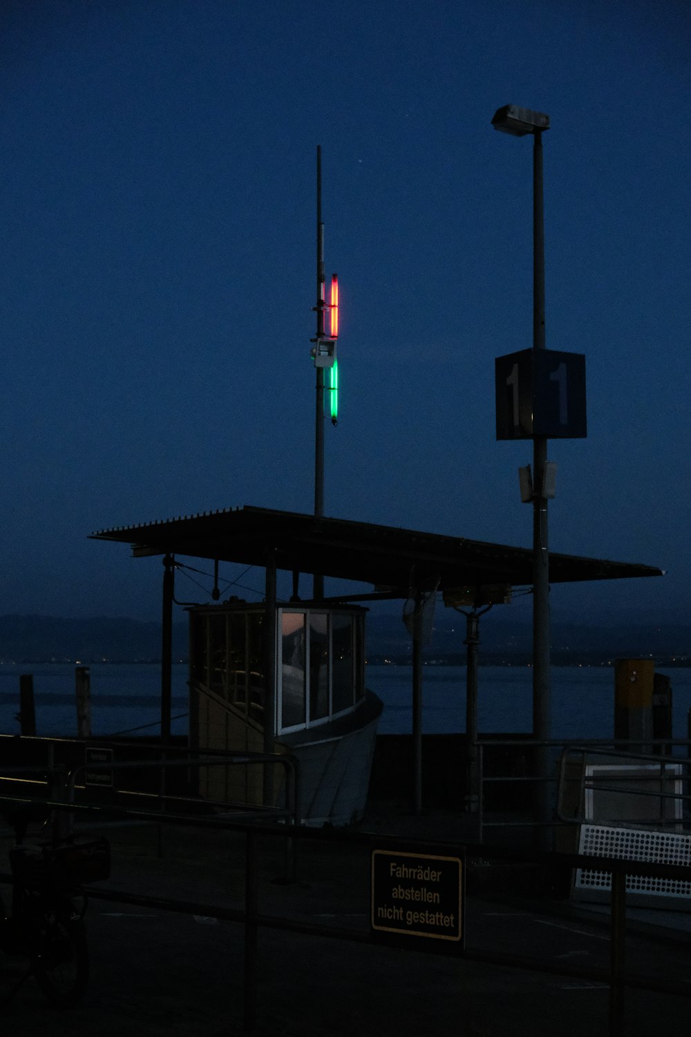 a stop light on a pole next to a boat