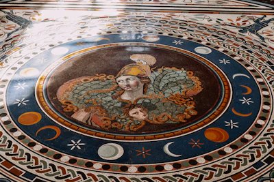 A vibrant mosaic artwork blending symbols from Greek and Georgian mythology, with intricate patterns and mythical creatures intertwined.