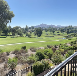 a view of a golf course from a balcony