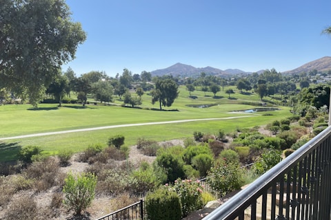 a view of a golf course from a balcony