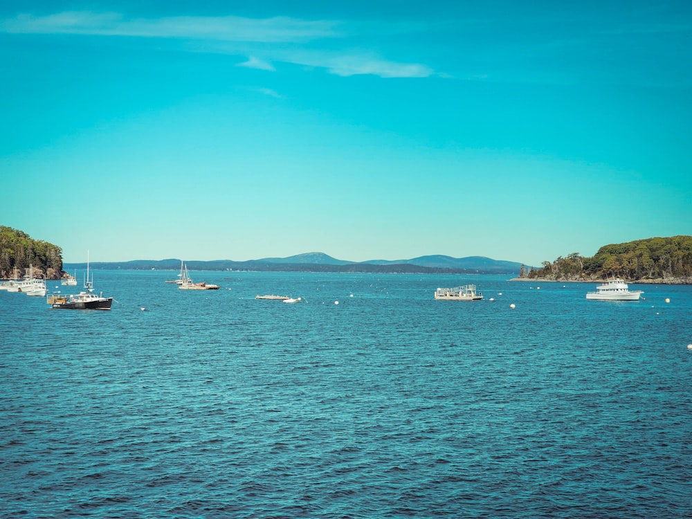 a group of boats floating on top of a large body of water