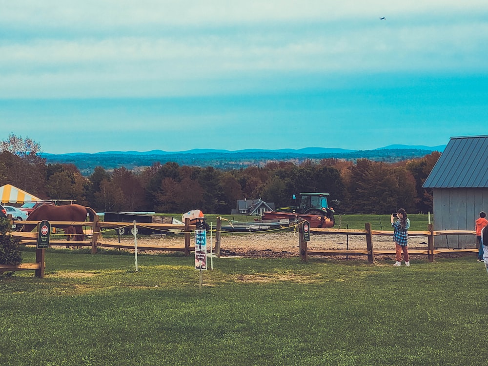 a couple of people that are standing in the grass