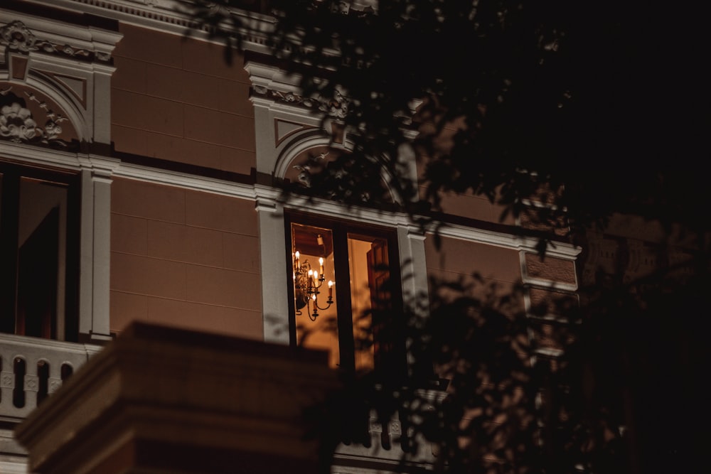 a building with a lit up window at night