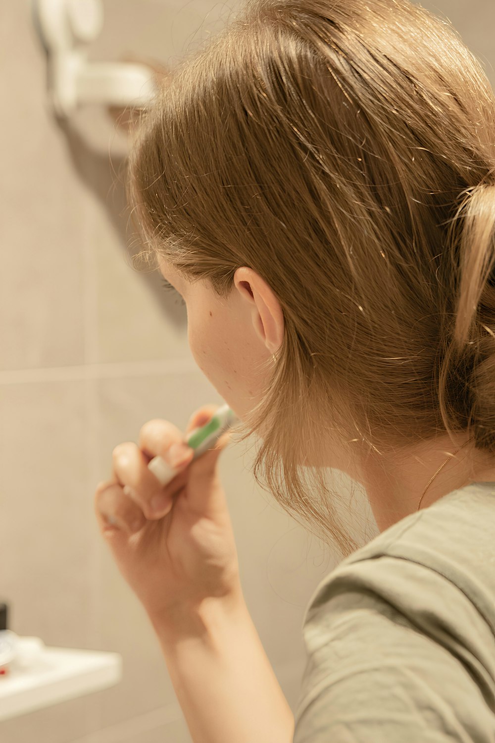 a woman brushing her teeth in a bathroom