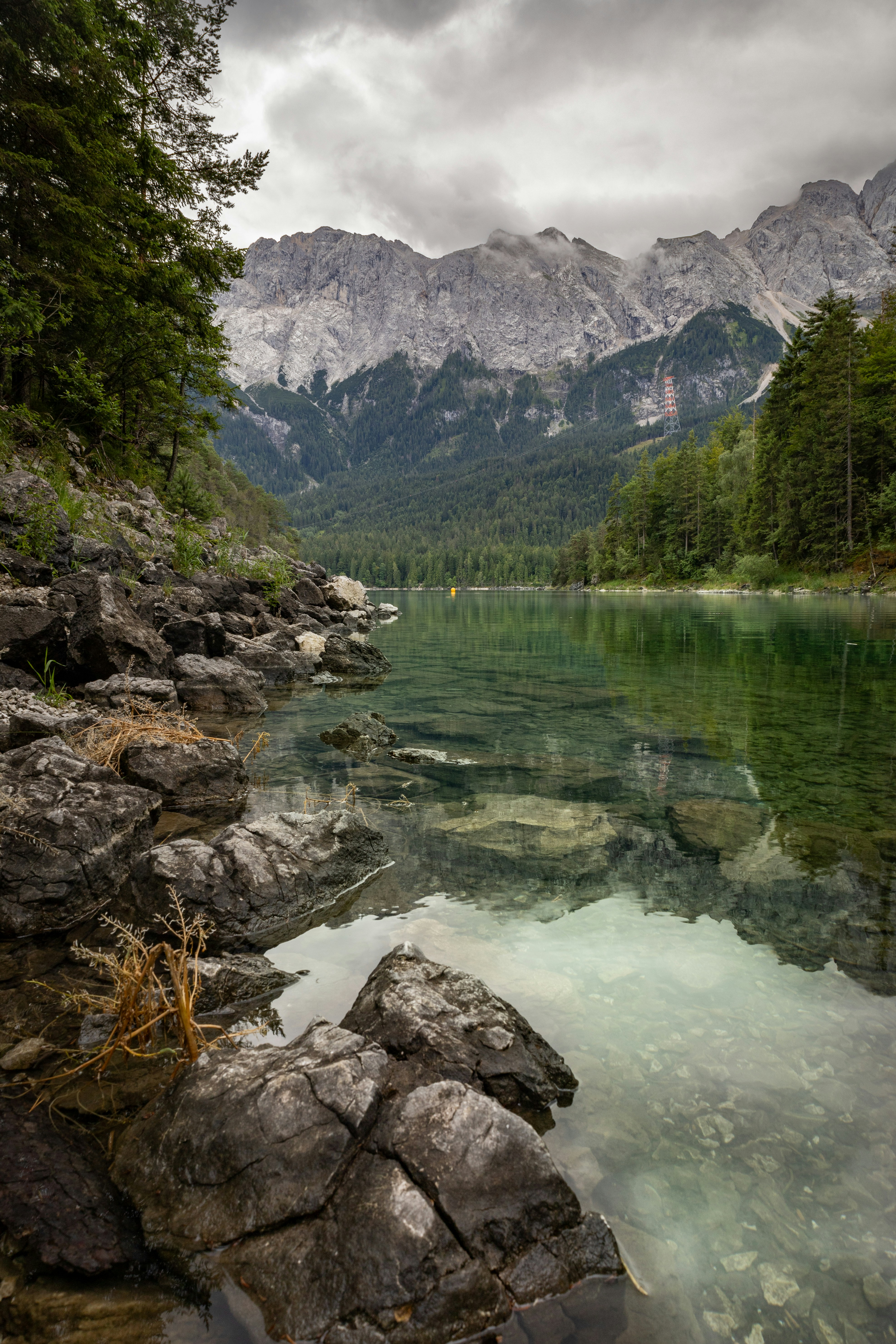 a body of water surrounded by mountains and trees