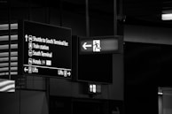 A c.a.r.e. shuttle arriving at the Fairfield Inn stop, framed by directional airport-style signs.