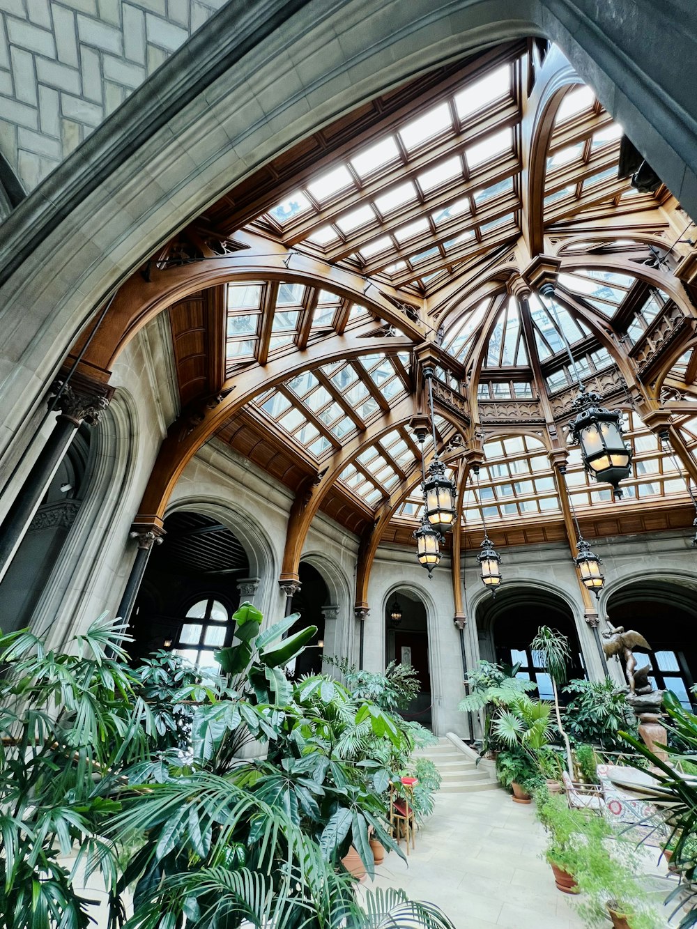 a large building with a glass ceiling and lots of plants