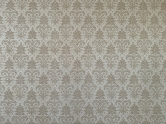 A classic damask wallpaper pattern featuring intricate floral motifs with a symmetrical design. The pattern is repetitive and evenly distributed across the surface, conveying a sense of elegance and tradition.