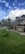 A beautiful residential property with a well-maintained garden and clear blue sky in the background.