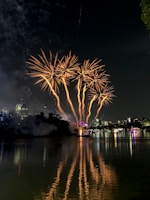 Golden fireworks cascading like shimmering rain over a cityscape at night.