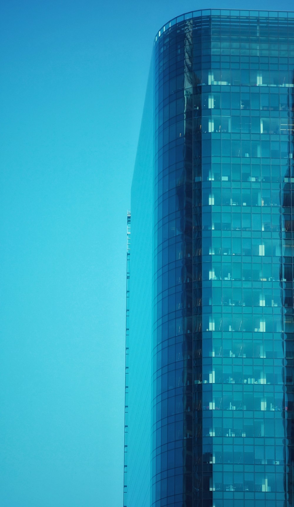 a very tall building with a plane flying in the background