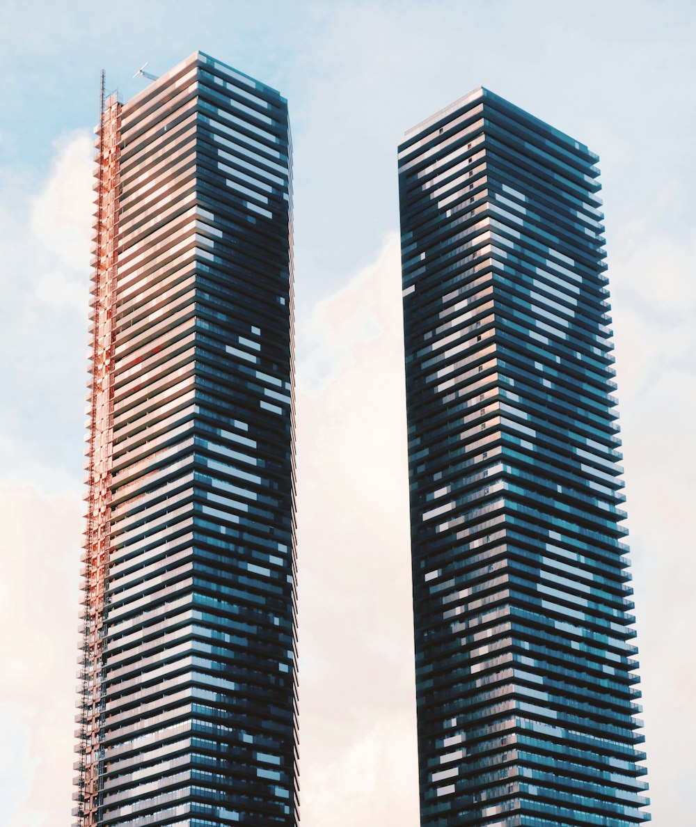 a couple of tall buildings sitting next to each other