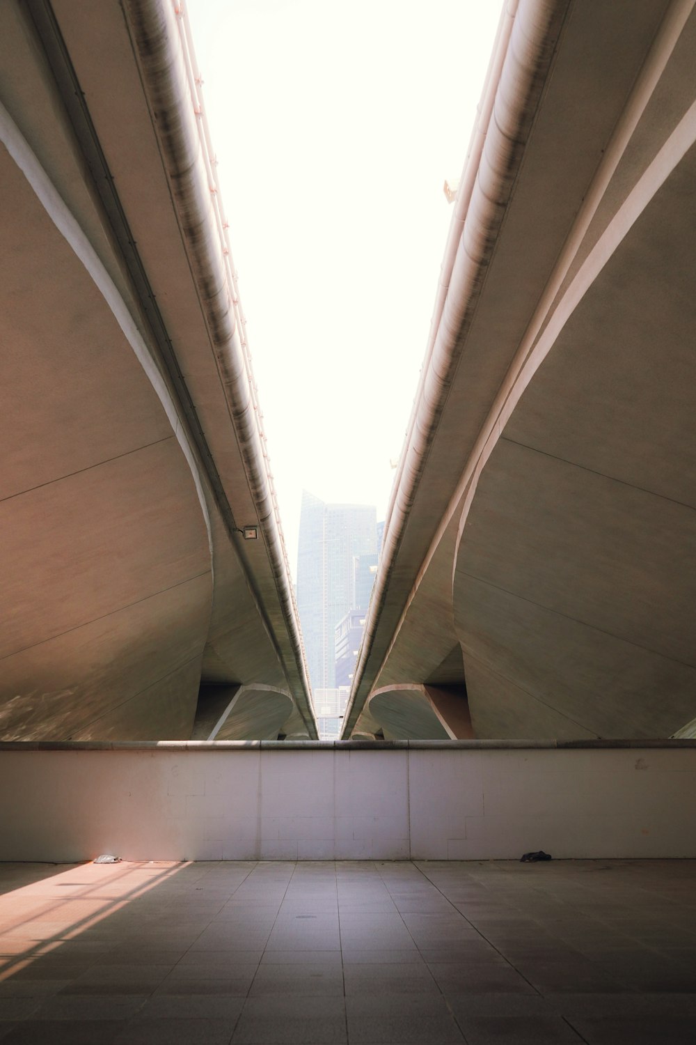 a view of the underside of a bridge from the ground
