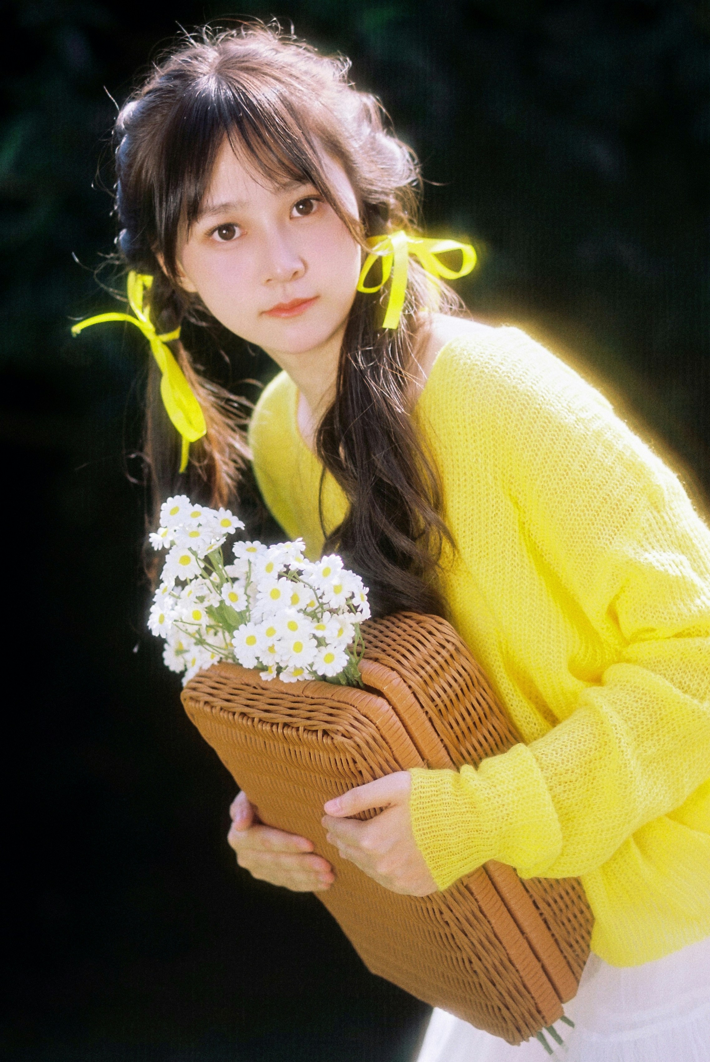a woman holding a basket with flowers in it