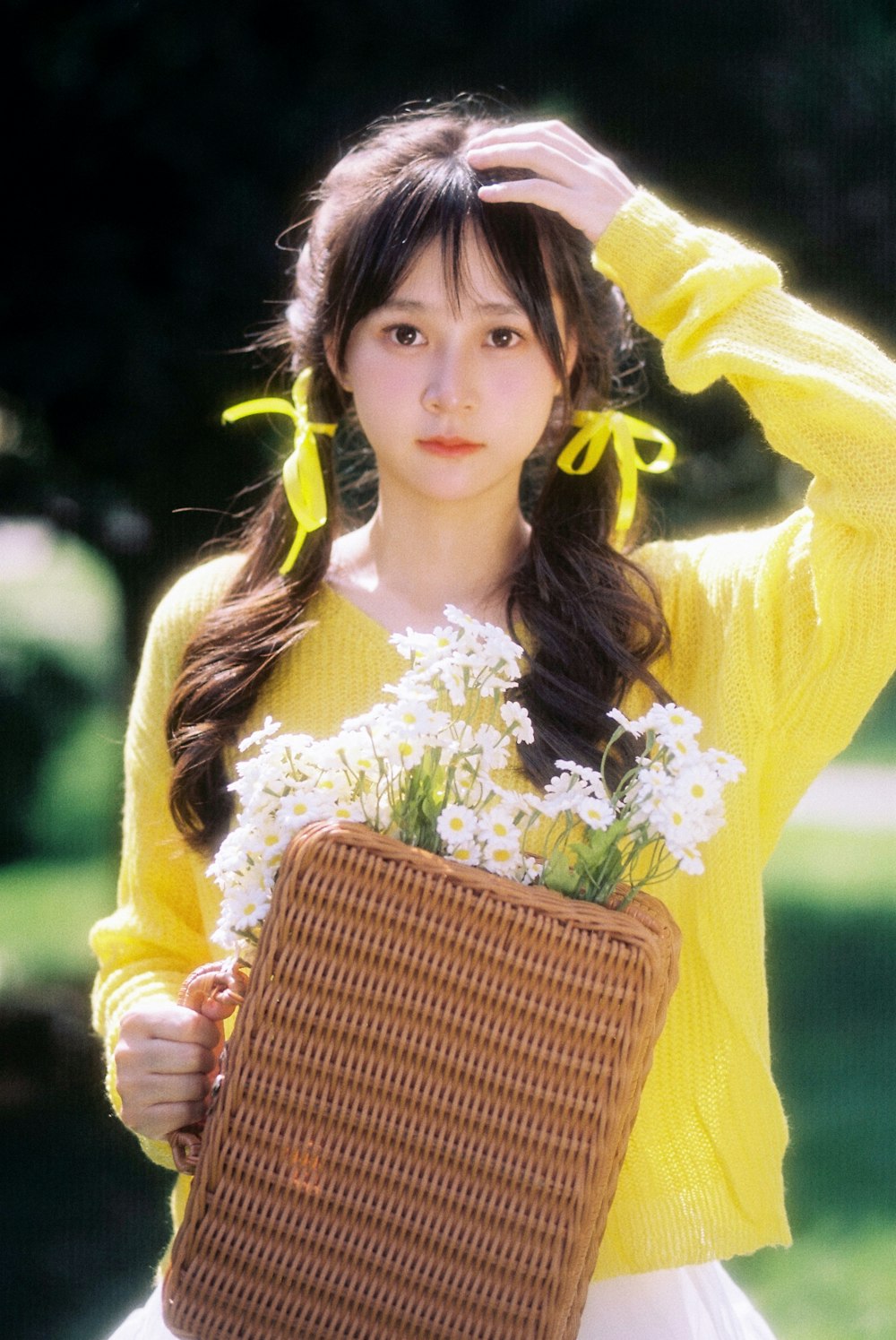 a woman holding a basket with flowers in it