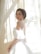 Close-up of a stylish woman wearing a fashionable dress in natural light.