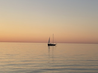 a sailboat floating in the middle of a large body of water