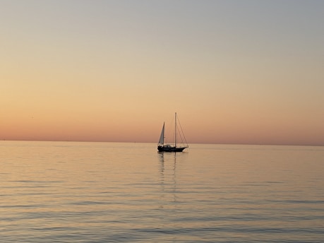 a sailboat floating in the middle of a large body of water