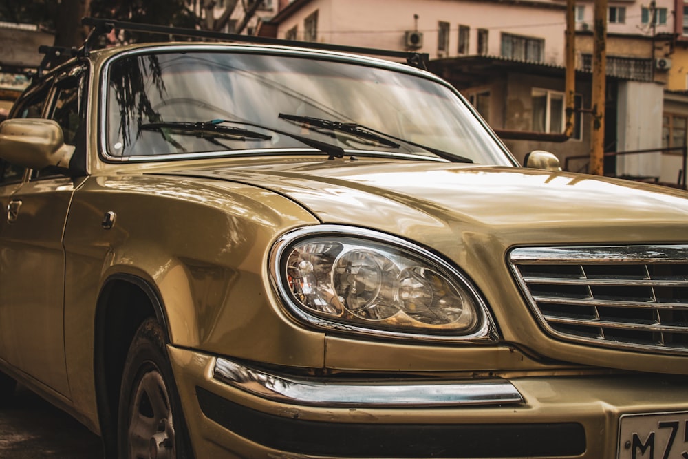 a gold car parked on the side of the road