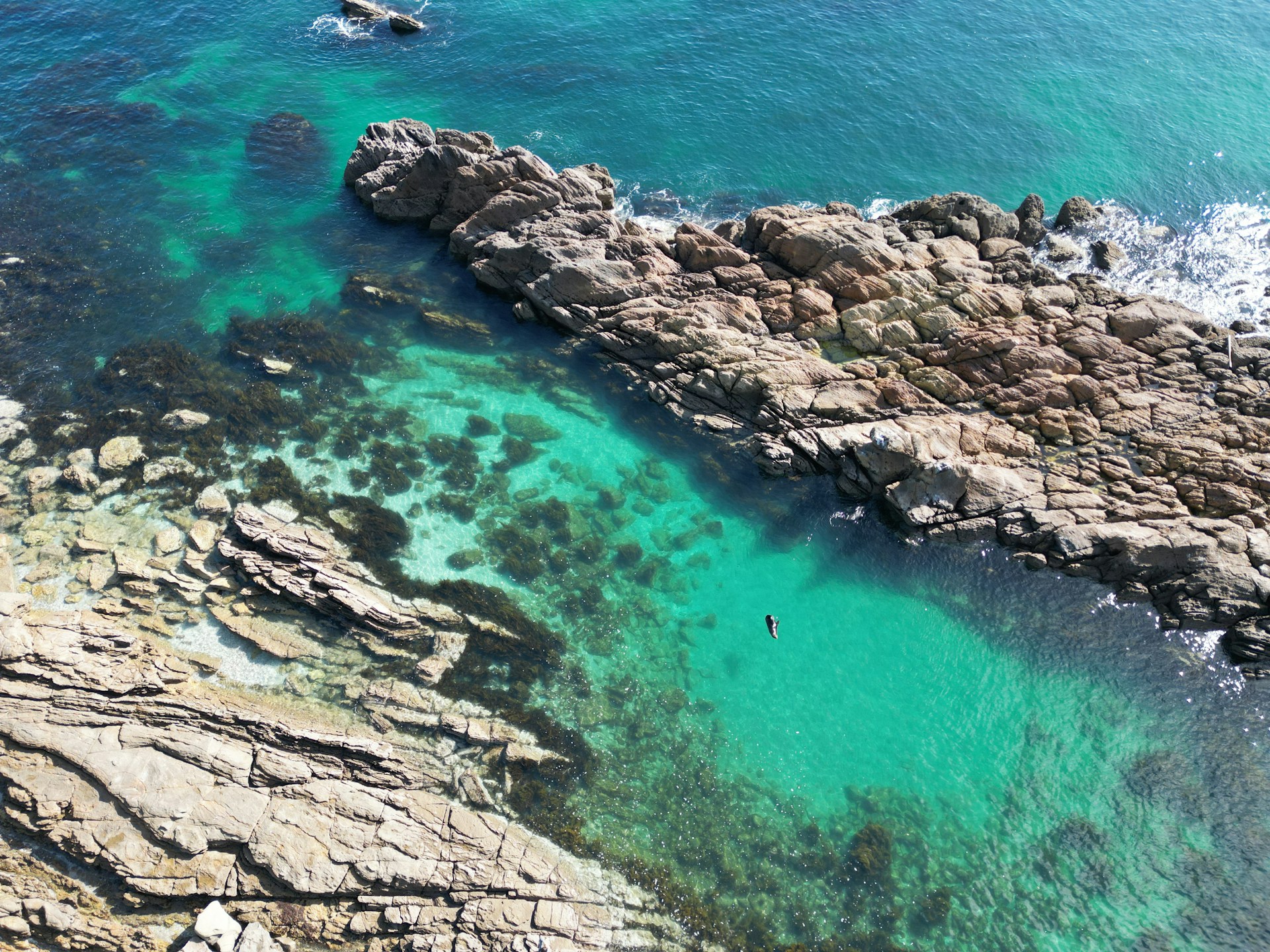 a body of water surrounded by rocks and water