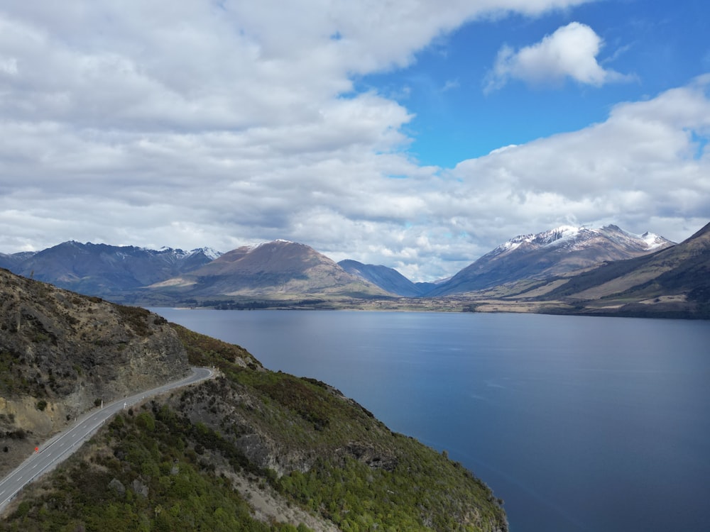 a scenic view of a lake with mountains in the background