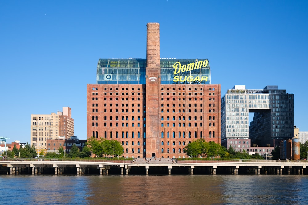 a large brick building sitting on the side of a river
