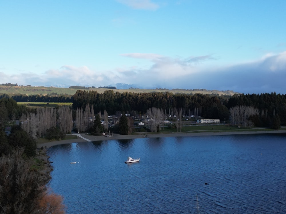 a small boat floating on top of a lake