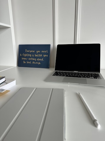 A serene office space with a desk, laptop, and inspirational quotes on the wall.