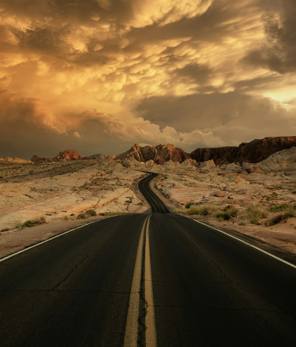 an empty road in the middle of a desert