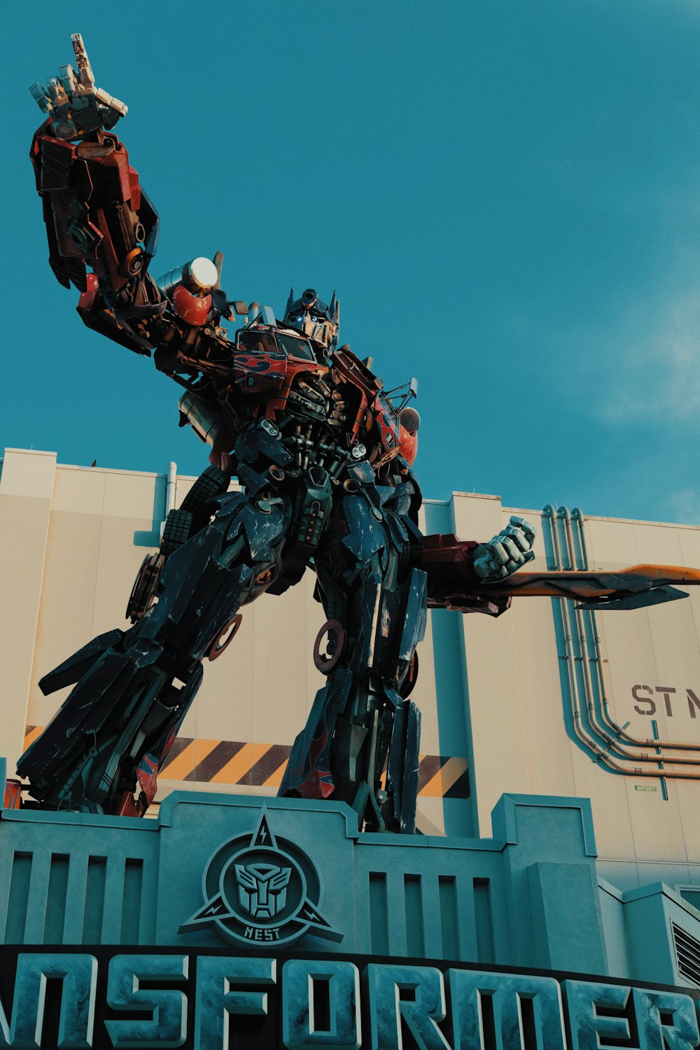 a giant statue of a transformer standing on top of a building