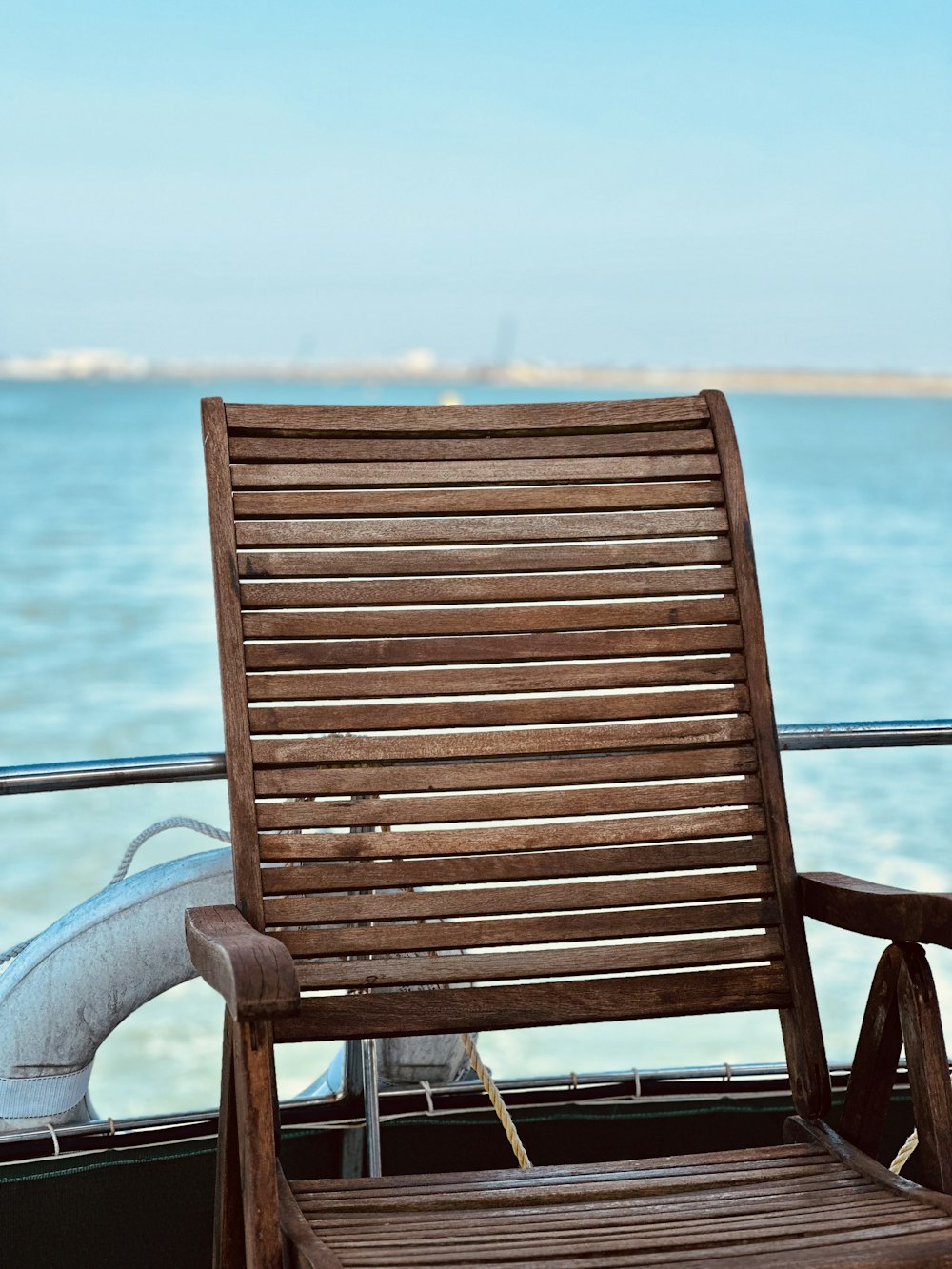 a wooden chair sitting on top of a boat