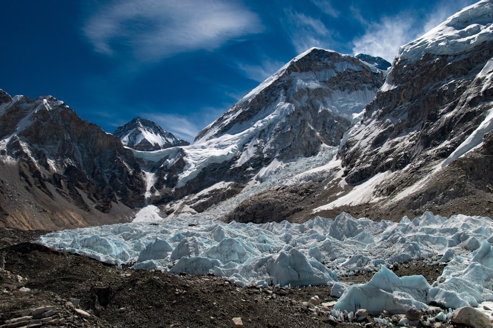 a large group of ice chunks in front of a mountain