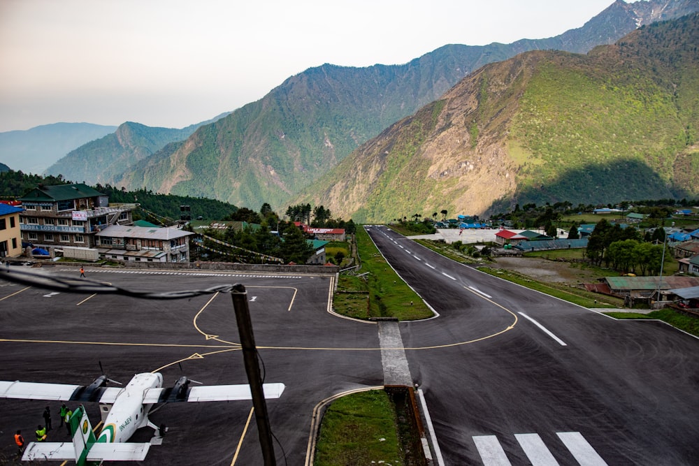 an airport runway with mountains in the background
