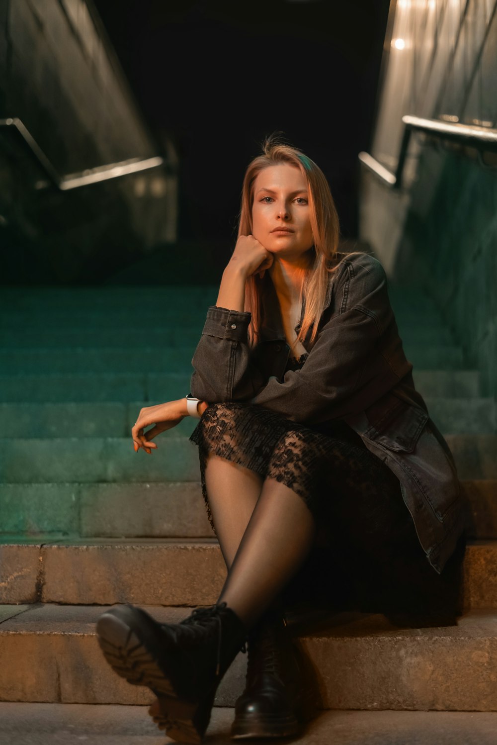 a woman sitting on the steps of a building