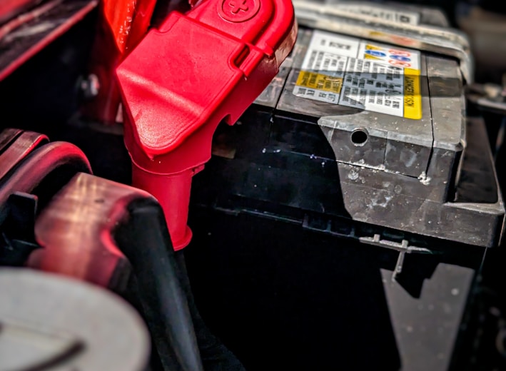 a red pair of pliers sitting on top of a car