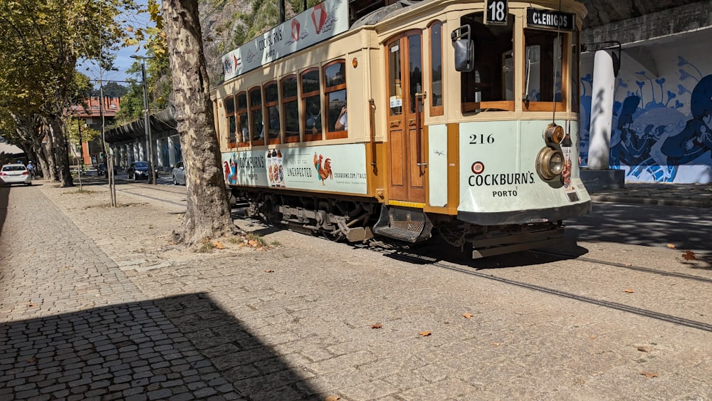 a trolley car is parked on the side of the road