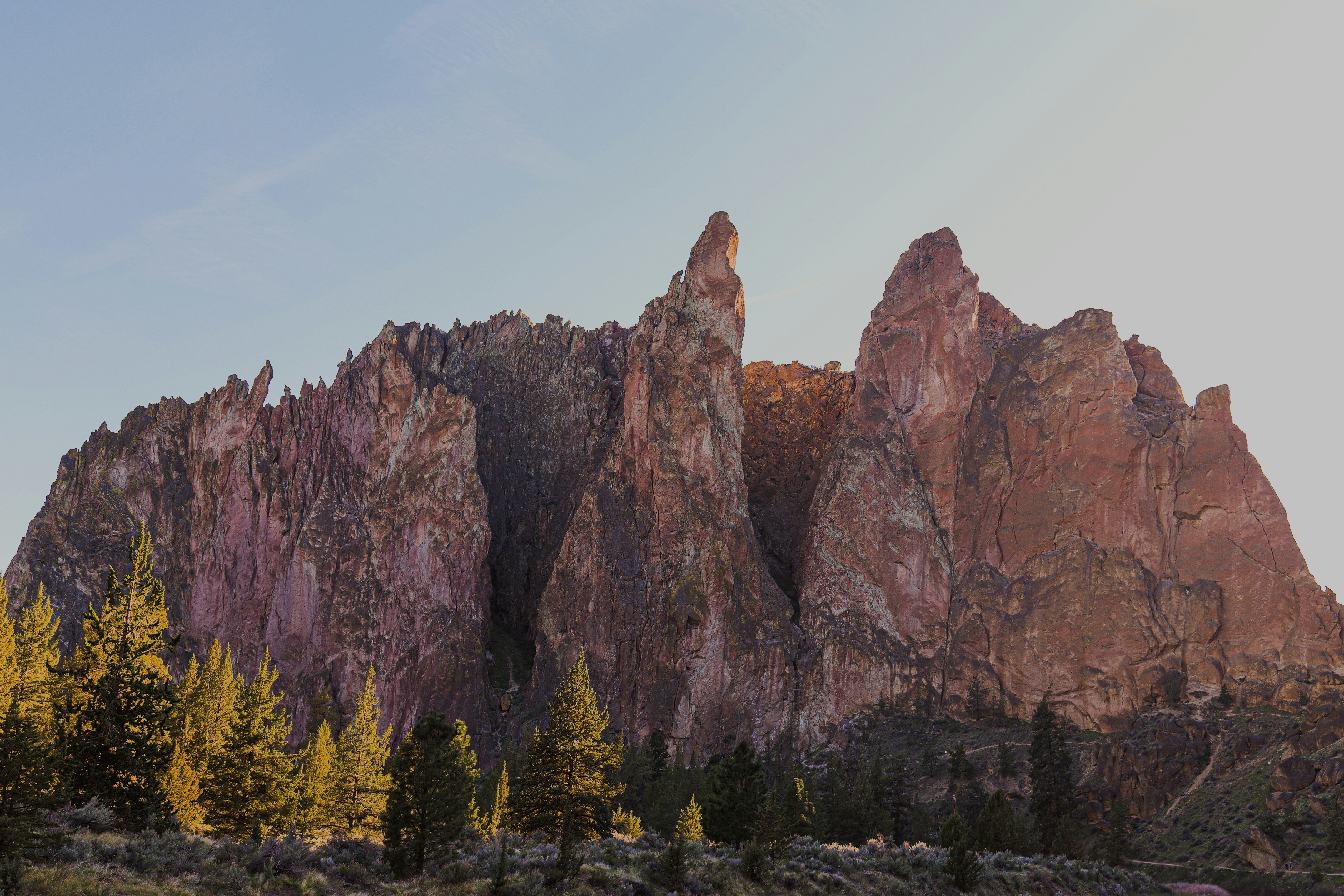 a group of mountains with trees in the foreground