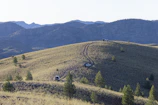 Wide shot of the hilly terrain showing 4WD tracks winding across the Scenic Rim.