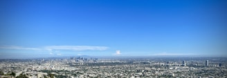 A panoramic view of a large-scale urban development project in the Middle East under clear skies.