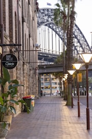 a street with a bridge in the background
