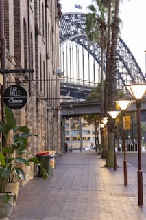 a street with a bridge in the background